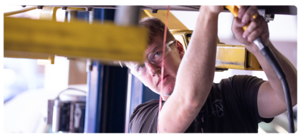 A student works in an auto bay